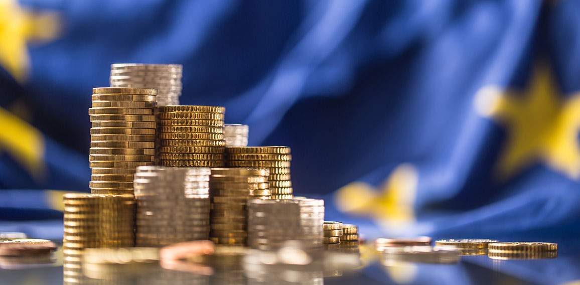 Towers with euro coins and flag of European Union in the background