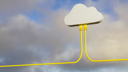 3D render: Cloud Computing Concept - Two Ethernet Cables plugged into a symbolic cloud. Real sky and cloud background.