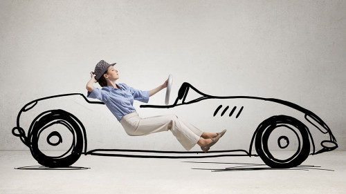 Woman driving old styled drawn car . Mixed media