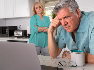 Older senior married couple in distress, concerned over mortgage