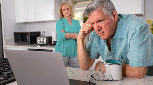 Older senior married couple in distress, concerned over mortgage