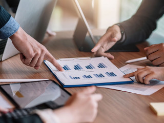 Close up view of business people investment advisors pointing at