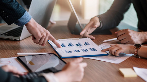 Close up view of business people investment advisors pointing at