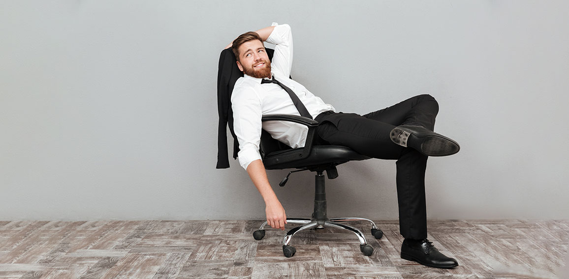 Smiling relaxed businessman resting in office chair