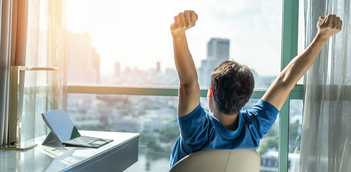 Business achievement concept with happy businessman relaxing in