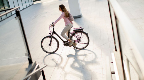 Young woman with modern city electric e-bike clean sustainable u