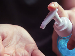 Woman using alcohol gel for cleaning hands prevention of coronav