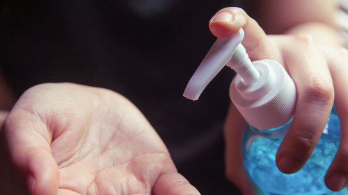 Woman using alcohol gel for cleaning hands prevention of coronav
