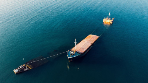 Sunken cargo ship near Crimean seaside, aerial view from drone.