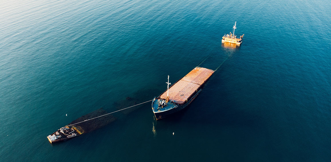 Sunken cargo ship near Crimean seaside, aerial view from drone.