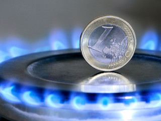 Burning natural gas and one euro coin on gas hob