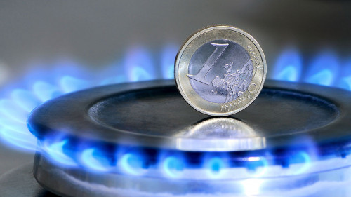 Burning natural gas and one euro coin on gas hob