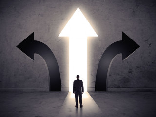 Businessman in front of three arrows