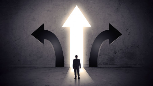 Businessman in front of three arrows