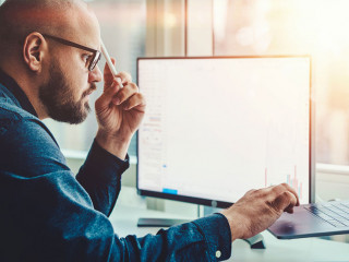 Professional male currency trader making research in financial m