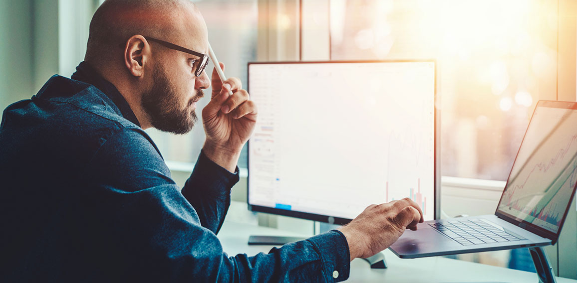 Professional male currency trader making research in financial m