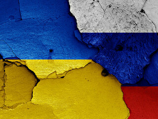 flags of Ukraine and Russia painted on cracked wall