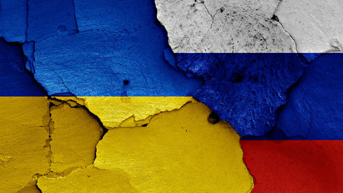 flags of Ukraine and Russia painted on cracked wall