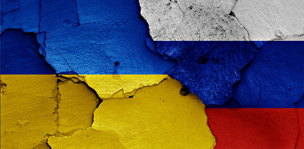 flags of Ukraine and Russia painted on cracked wall