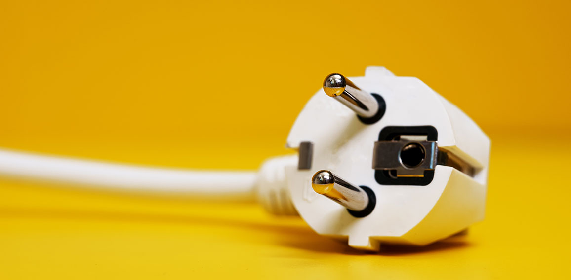 AC power plug on yellow background.