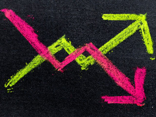 Hand drawing of green and red chalk in up and down arrow shape o