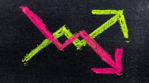 Hand drawing of green and red chalk in up and down arrow shape o