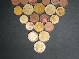 Christmas tree made out of Euro coins on slate plate.