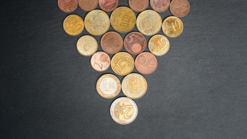 Christmas tree made out of Euro coins on slate plate.