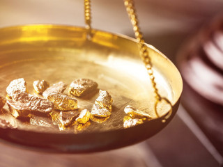 Small gold nuggets in an antique measuring