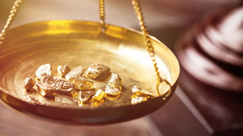 Small gold nuggets in an antique measuring