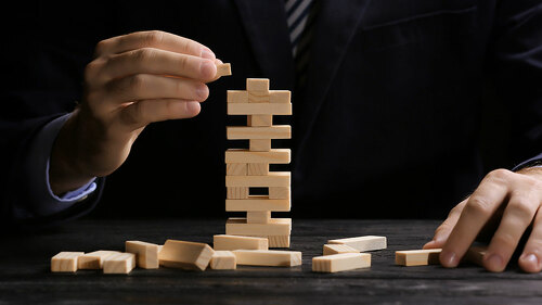 Young man with jenga at table
