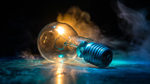 Abstract dark background with creative artwork decoration of glowing bulbs.