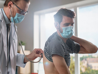 Doctor Consultation Office: Physician Listens to Patient's Lungs