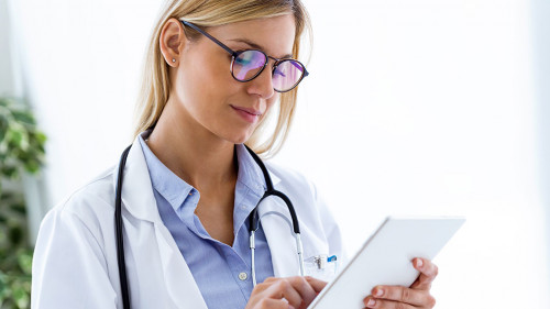 Female doctor using her digital tablet in the consultation.