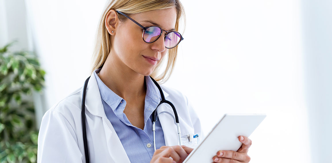 Female doctor using her digital tablet in the consultation.
