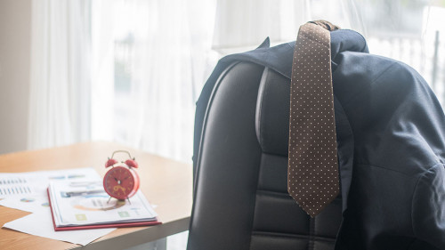 Close-up Of Necktie And Blazer On Chair In Office