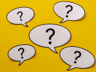 Five speech bubbles with question marks over a bright yellow background