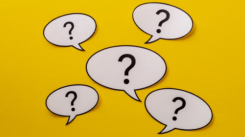 Five speech bubbles with question marks over a bright yellow background