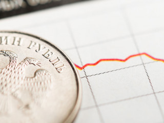 One rouble coin on fluctuating graph. Rate of the Russian rouble