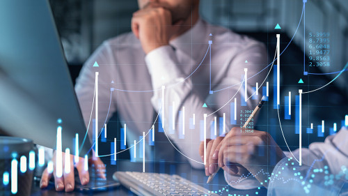 Two colleagues in formal wear working together to optimize trading strategy at corporate finance fund. Forex chart hologram over modern office background