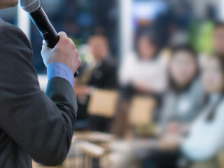 Conference with panel speakers on stage during debate. Presenter