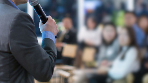 Conference with panel speakers on stage during debate. Presenter