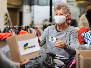 Volunteers collecting donations for the needs of Ukrainian migrants, humanitarian aid concept.