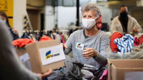 Volunteers collecting donations for the needs of Ukrainian migrants, humanitarian aid concept.