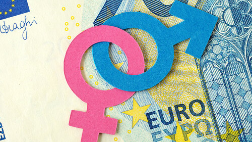 Male and female gender symbols chained together on euro banknote