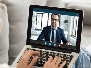 Computer screen monitor view over female shoulder