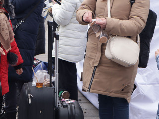 Russia's war with Ukraine. Refugees with suitcases in Lviv at the station, hungry, eat standing up