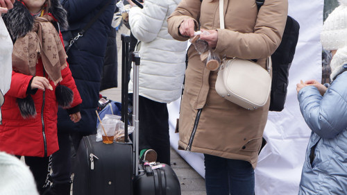 Russia's war with Ukraine. Refugees with suitcases in Lviv at the station, hungry, eat standing up