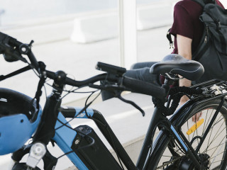 Close up electric bicycle with sitting man in background