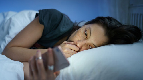 Unhappy girl follow cheating boyfriend in social media lying sleepless in bed suffer from insomnia